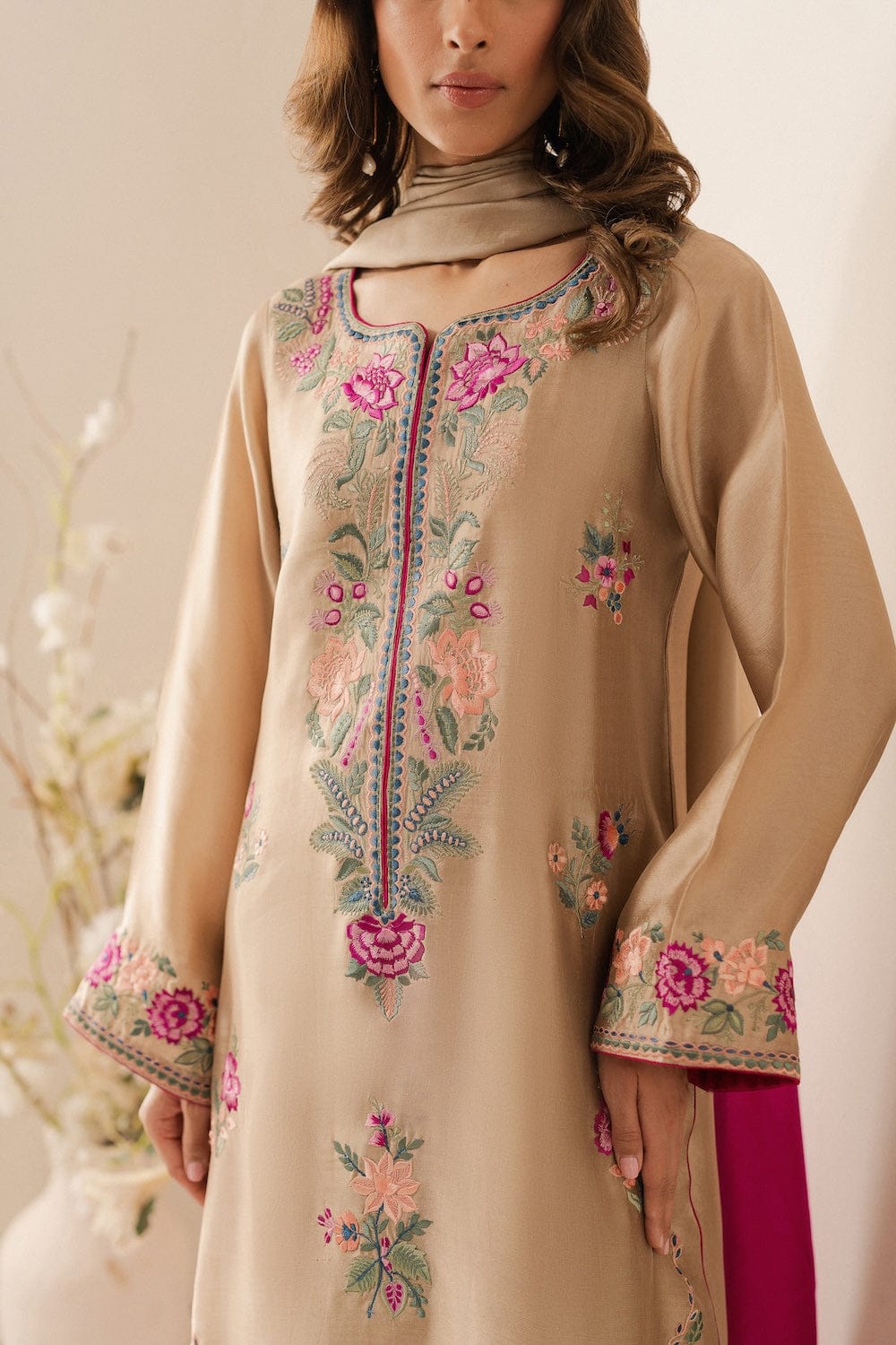Beige lawn suit neckline and floral embroidery close up
