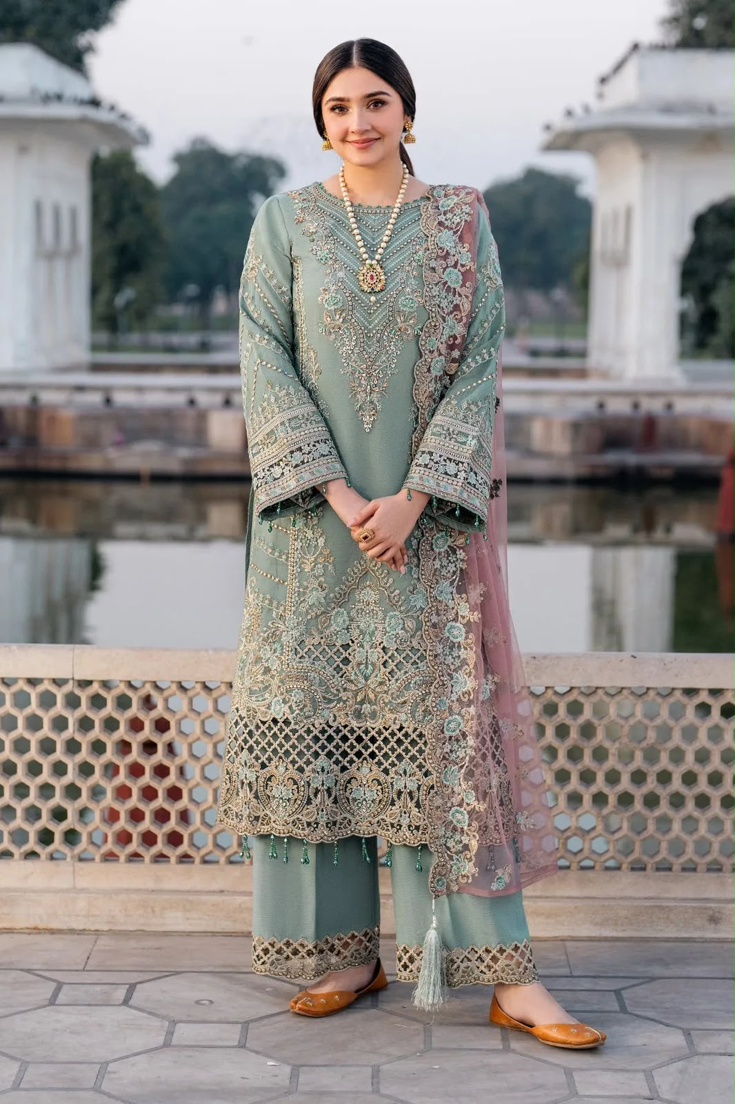 Dusty sage green heavy embroidered suit with net dupatta front model view