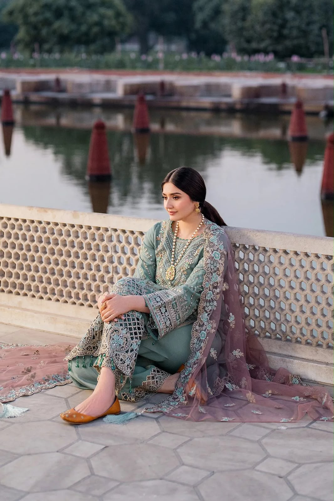 Dusty sage green heavy embroidered chiffon net 3 piece unstitched suit sitting model view
