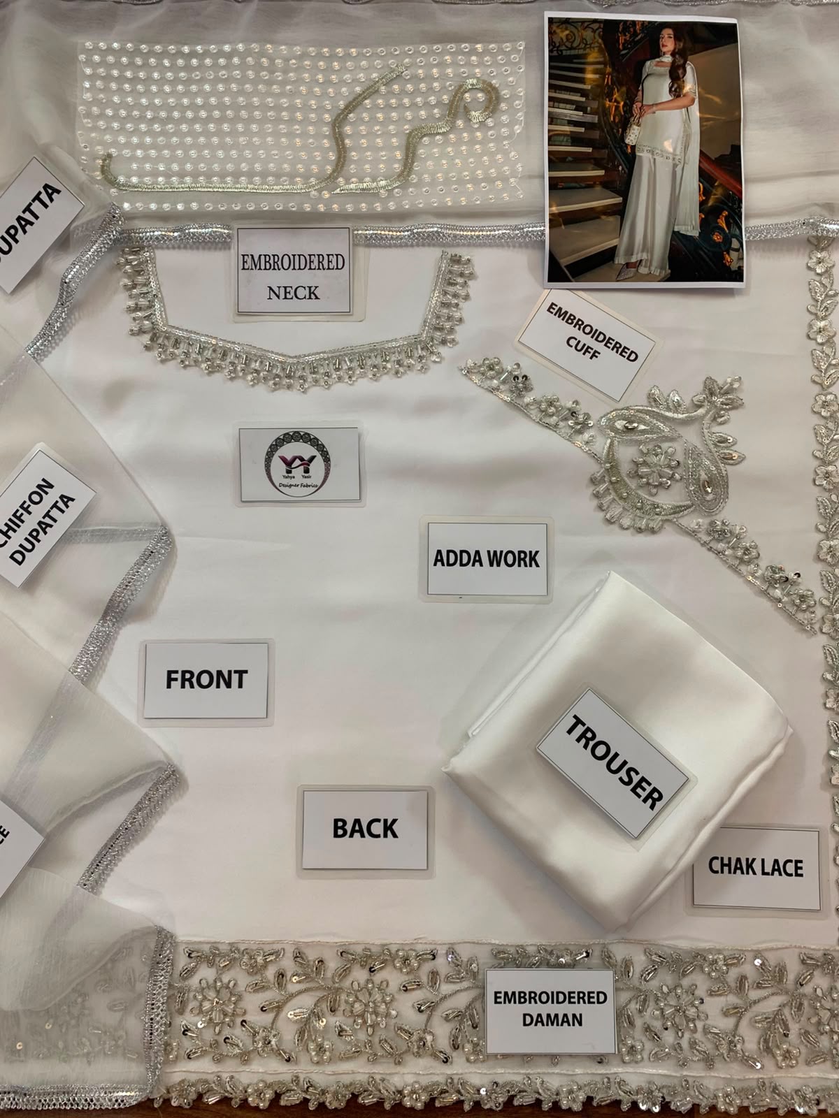 Pearl white shamoz silk unstitched suit flat lay with shirt trouser dupatta and patches