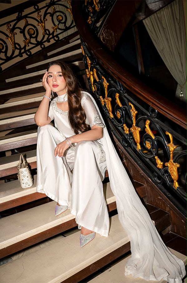 Pearl white shamoz silk unstitched suit styled on staircase
