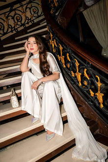 Pearl white shamoz silk unstitched suit styled on staircase
